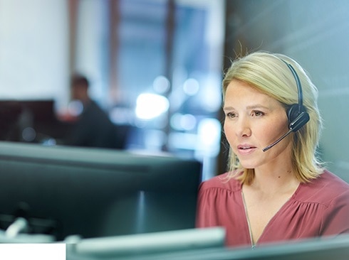 A female call center employee working on a monitor